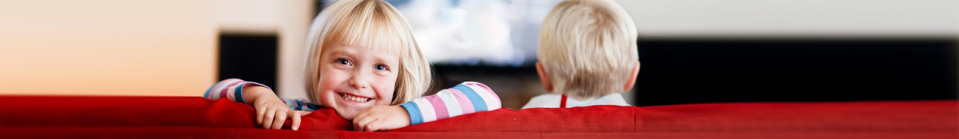 Girl-looking-back-at-you-while-brother-watches-tv-GettyImages-157592182